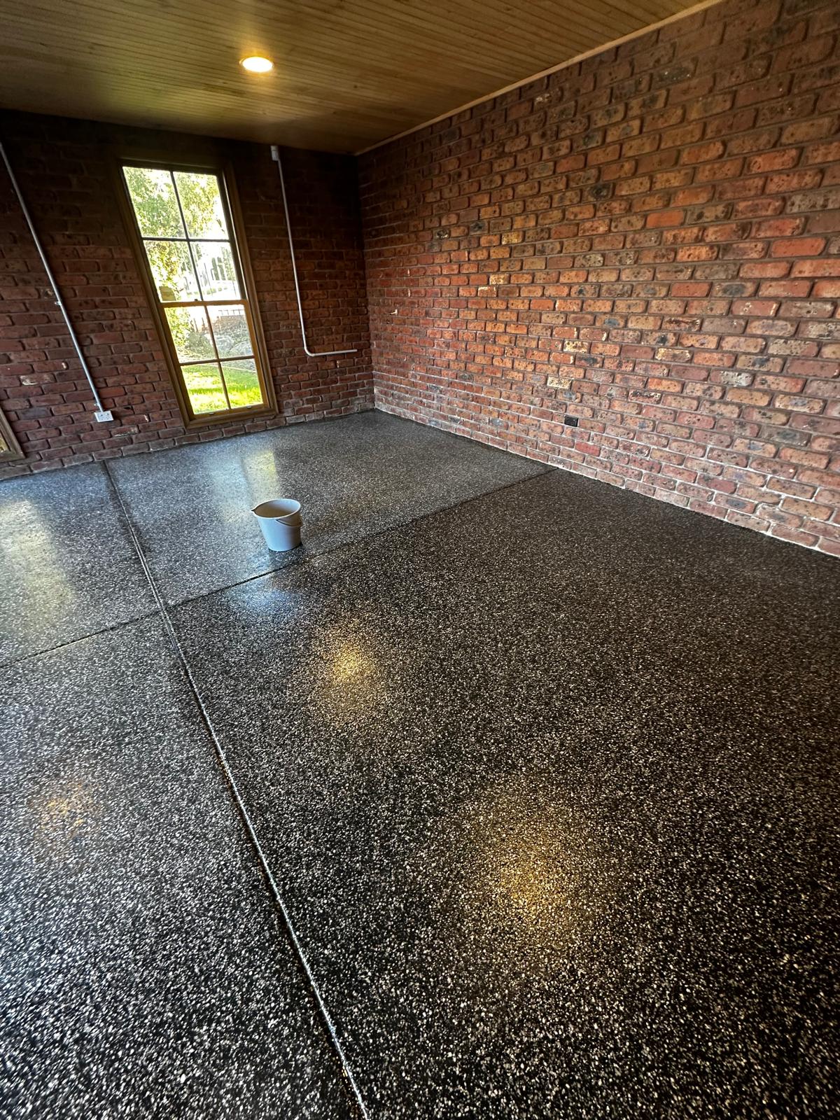 Double garage epoxy floor timber ceiling brick walls
