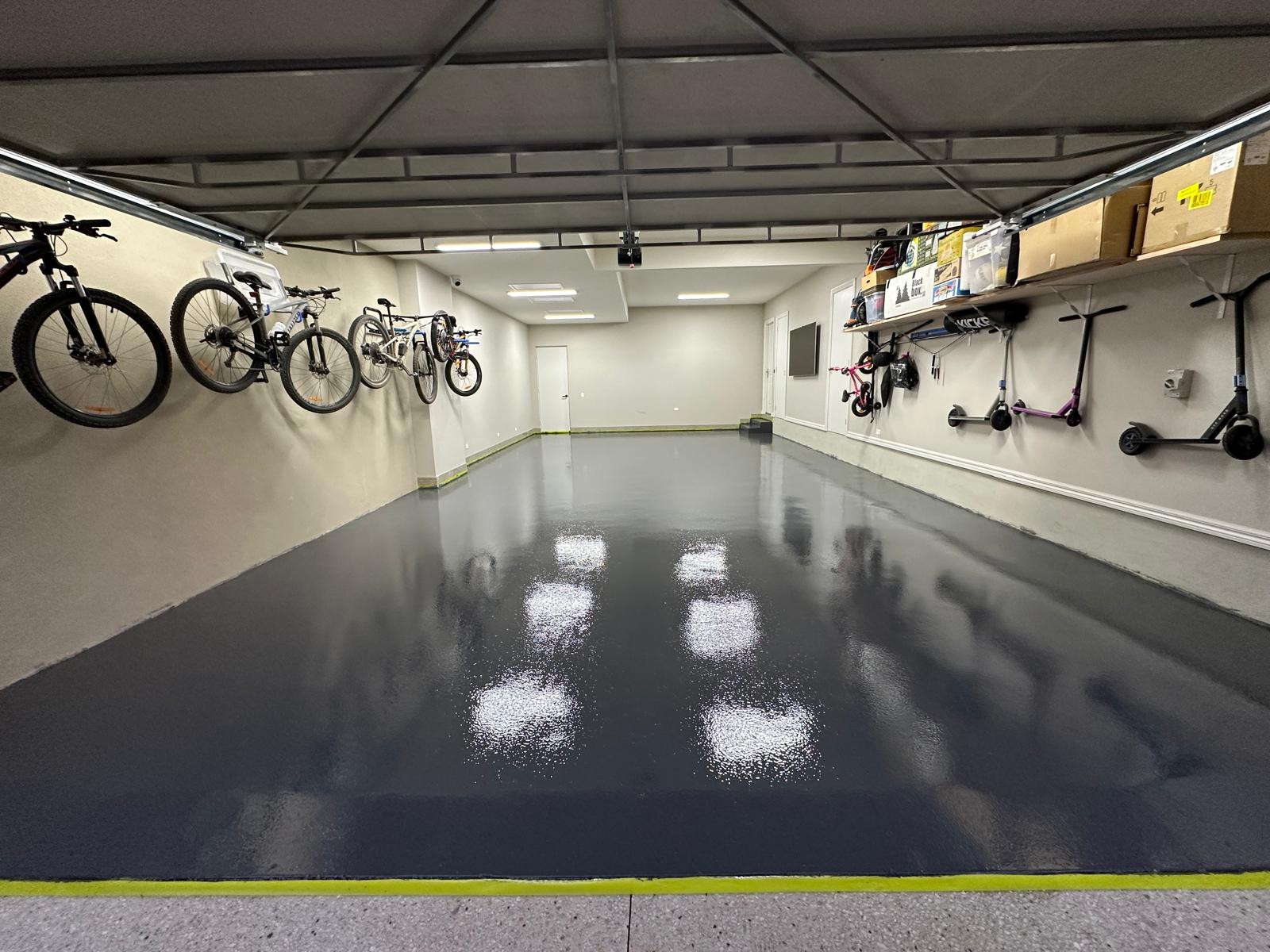 Charcoal epoxy floor in a Heidelberg triple garage used for bike and scooter storage