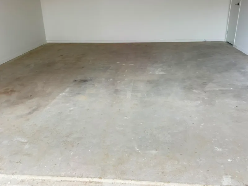Officer garage slab paint splatter plaster before grinding