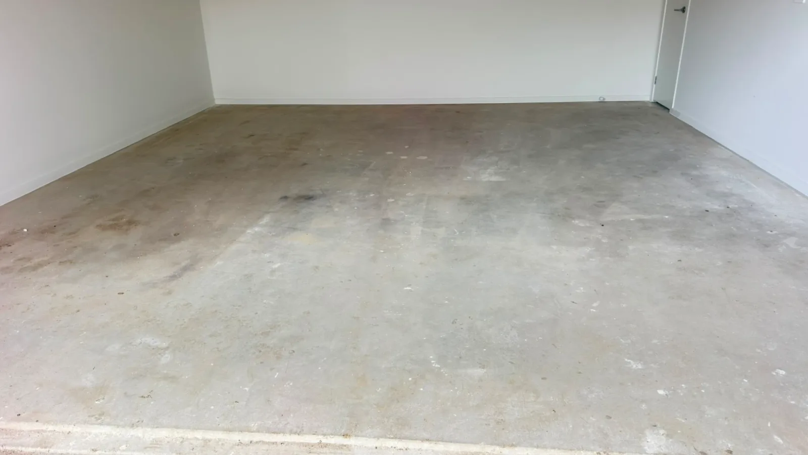 Officer garage slab paint splatter plaster before grinding