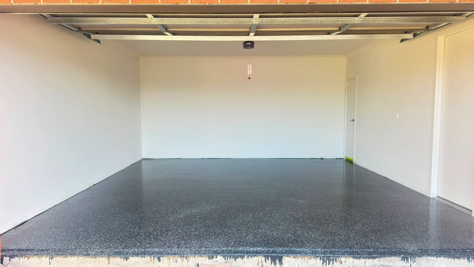 Finished charcoal flake epoxy floor in an Officer double garage