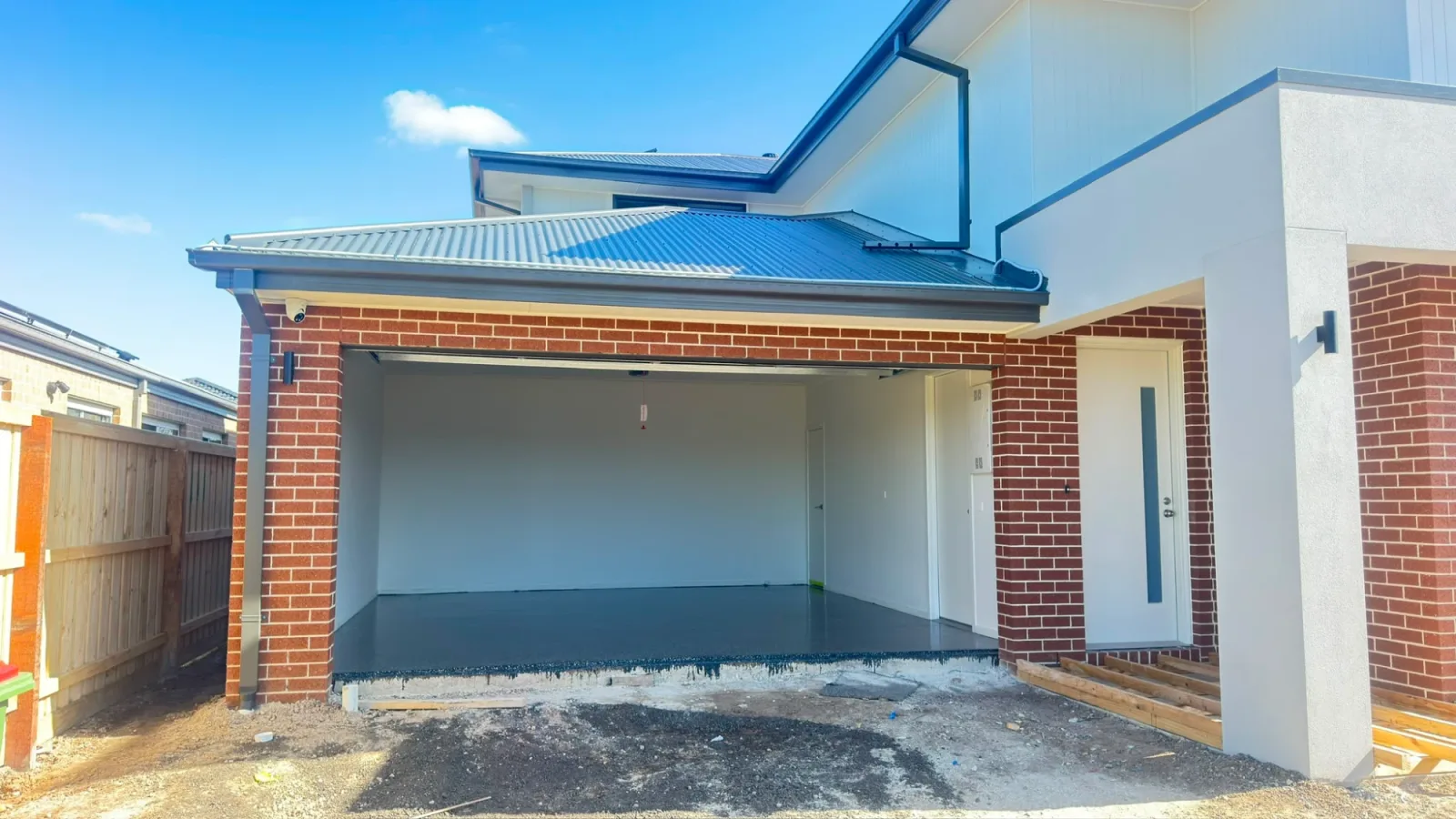 Completed epoxy garage floor viewed from outside a new build home in Officer, before the driveway was poured