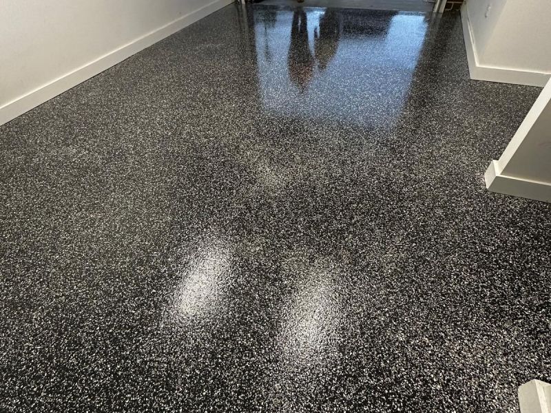 Single garage epoxy floor installation team on site