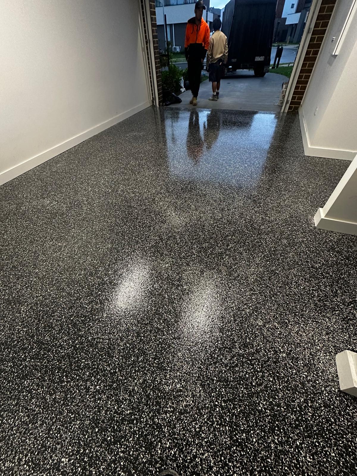GoPoxy installers applying a flake epoxy garage floor in Melbourne